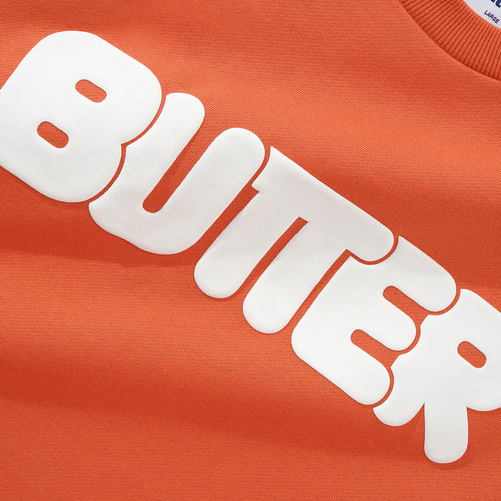 【BUTTER GOODS】 Rounded Logo Crewneck Sweatshirt, Orange Rounded Logo Crewneck Sweatshirt in Washed Orange by Butter