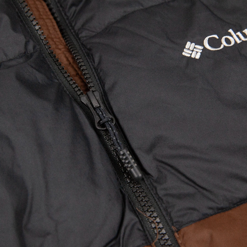 Close-up of a Columbia jacket with a zipper and brown interior.