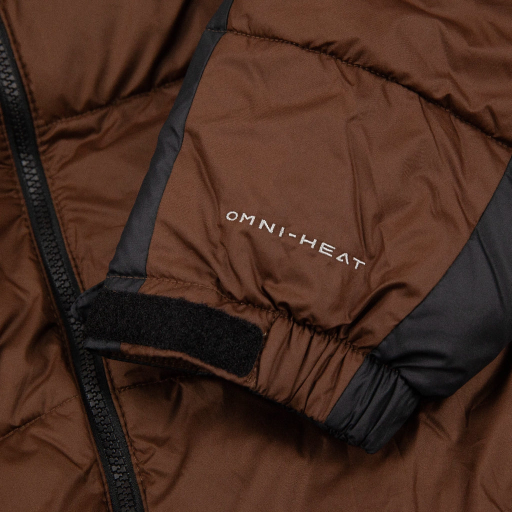 Brown Columbia puffer jacket with 'OMNI-HEAT' branding on a dark background
